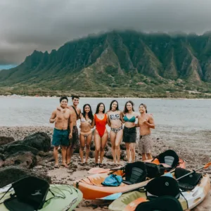 Kayak and beach gear laid out on sandy shore
