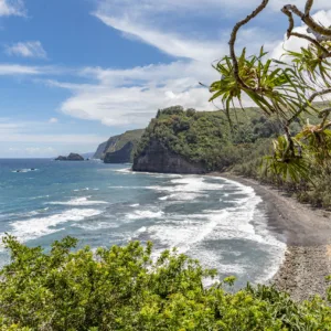 Hikers descending trail toward Pololu Valley beach