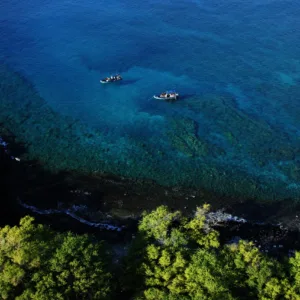 Boat cruising near sea caves on Kanaio Coast