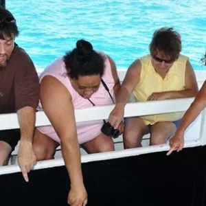 Glass bottom boat floating over coral reef