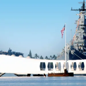 Historic battleship docked at Pearl Harbor with visitors