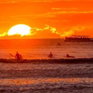 Group enjoying a glass bottom boat tour at sunset