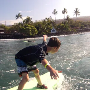 Surf instructor coaching solo student on Hawaiian beach