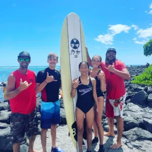Small group learning to surf with private lifeguard coach