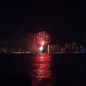 Boat cruising Waikiki coast at night