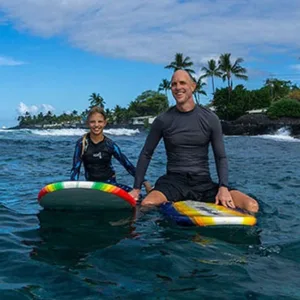 Group of beginners learning to surf on beach