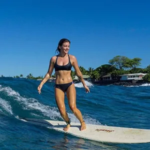 Surf instructor giving private lesson to surfer