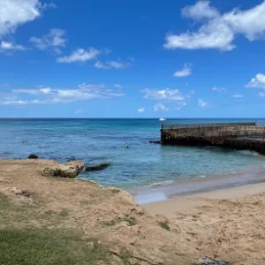 Diver entering shallow sandy shore at E-Beach