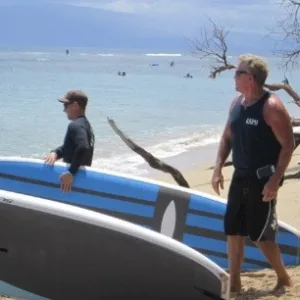 Individual receiving private paddleboard lesson from instructor