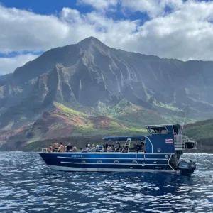 Boat cruising along Na Pali Coast waters