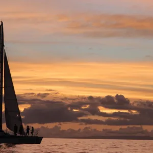 Catamaran cruising Maui’s Auau Channel at sunset