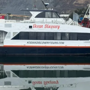 Tour boat cruising along Alaskan historic waterfront