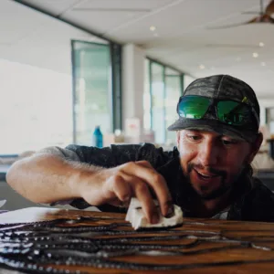 Artist applying traditional inks to fish for printing