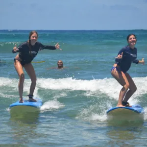 Surf instructor coaching beginner at Kiahuna Beach