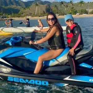 Person preparing jet ski on tropical beach